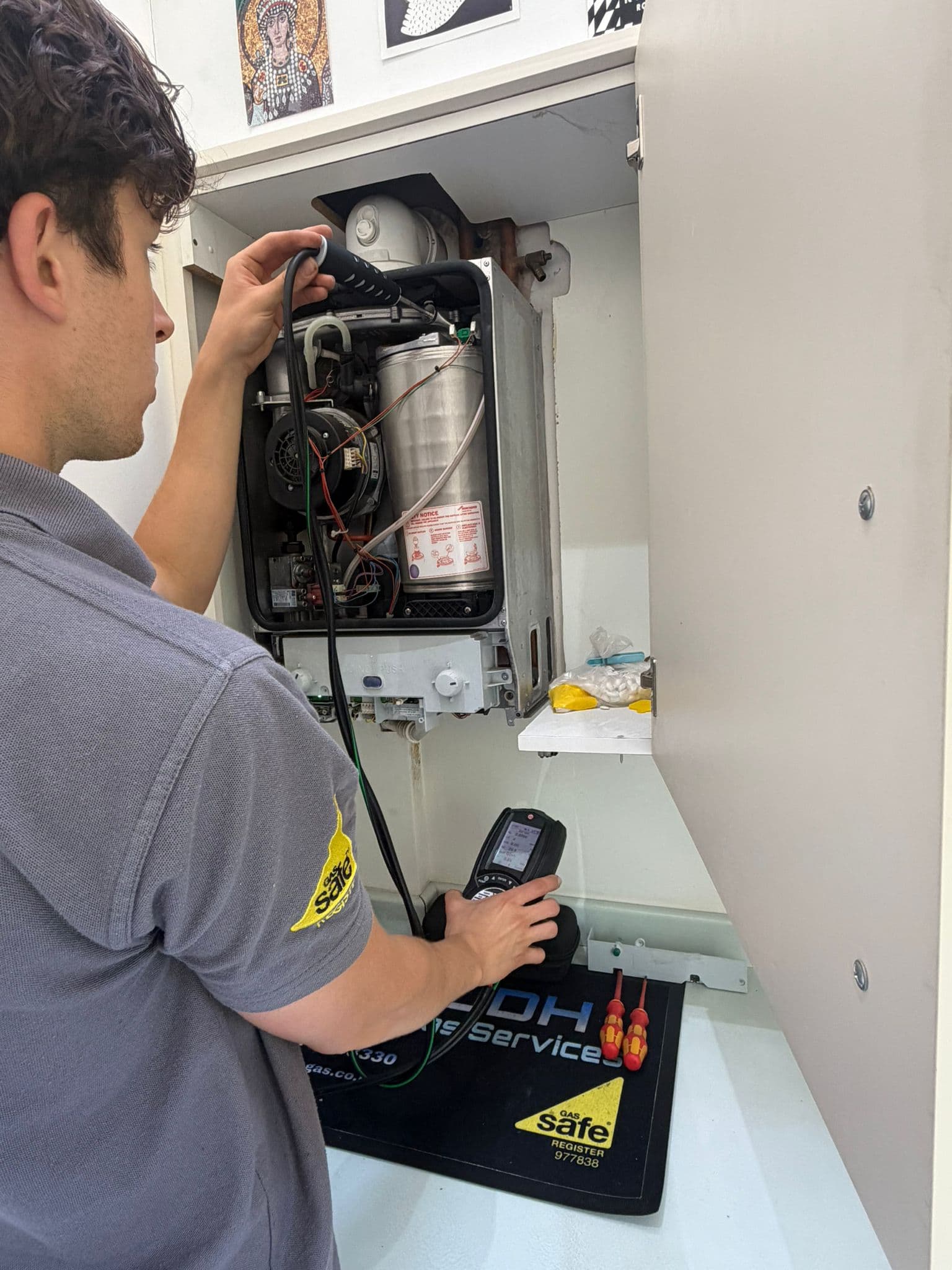 Jamie Hannah, Gas Safe registered engineer covering Horsham, testing a boiler with a flue gas analyser probe