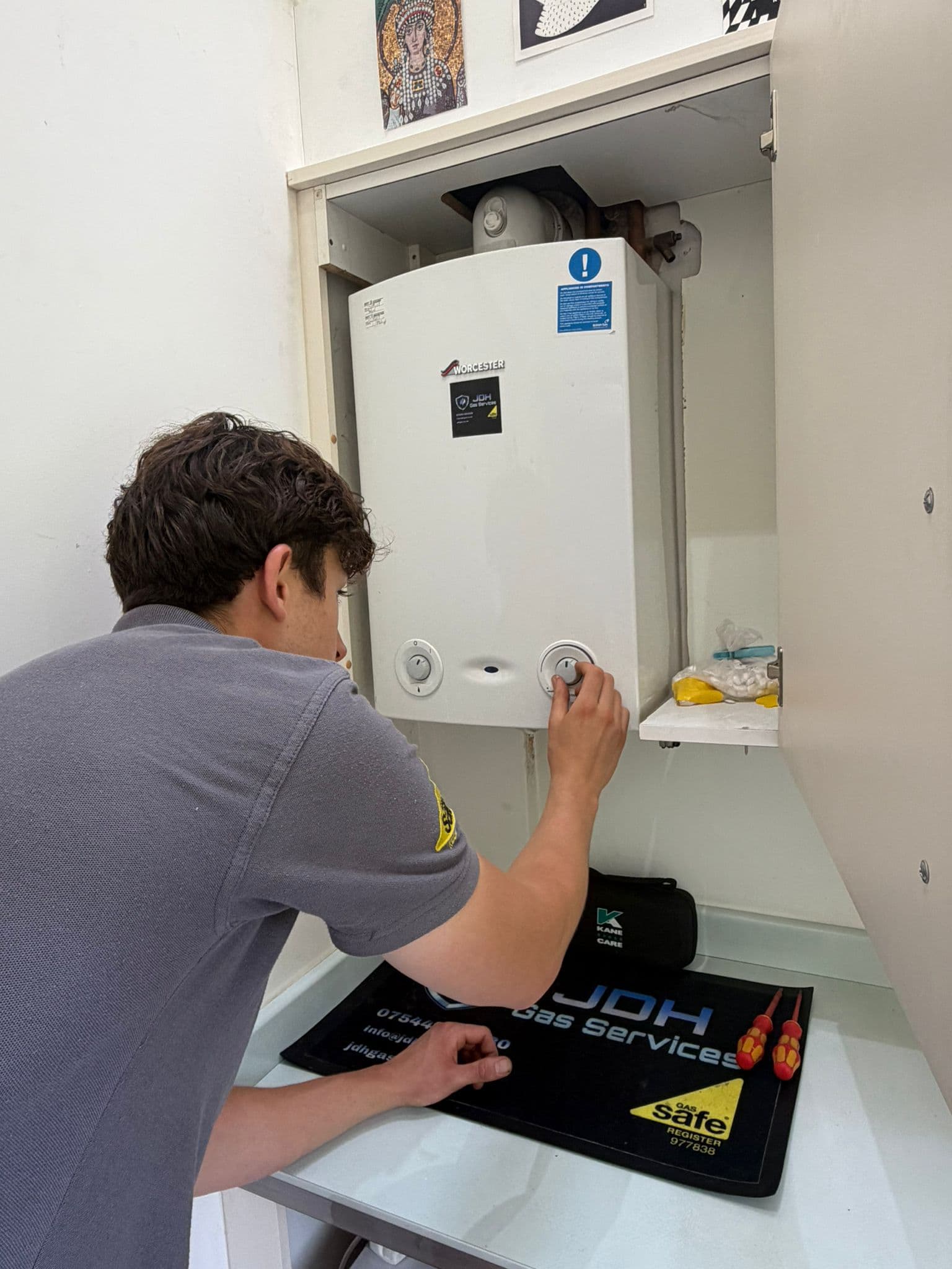 Jamie Hannah, Gas Safe registered engineer covering Cuckfield, checking the controls on a Worcester boiler