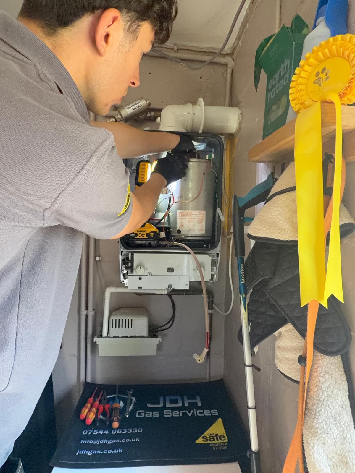 Jamie Hannah, Gas Safe registered engineer covering Keymer, inspecting an open Worcester boiler by torchlight during a service